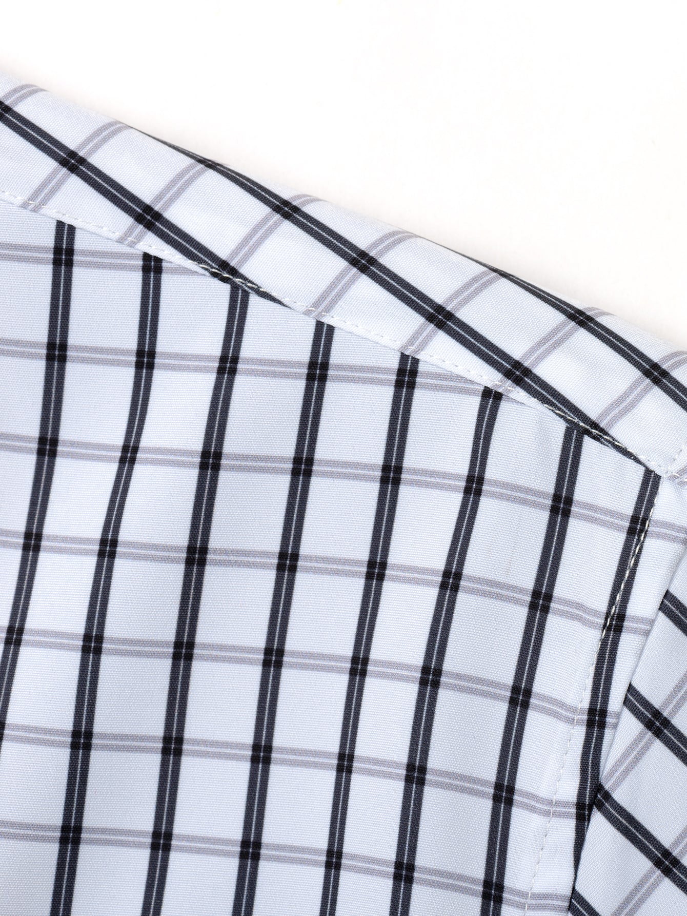 Long-sleeved button-down plaid shirt