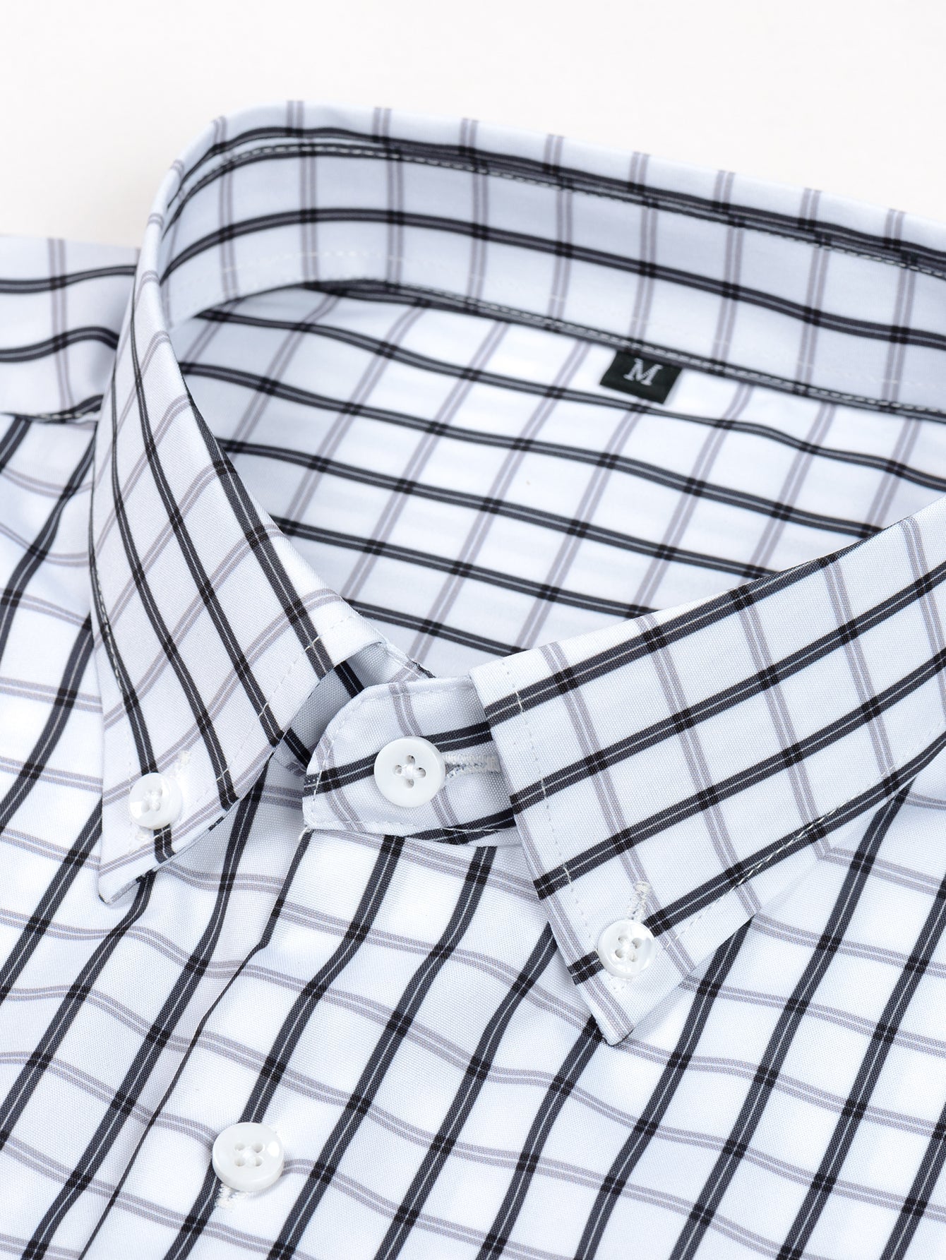 Long-sleeved button-down plaid shirt